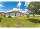 View of the cozy backyard with lush green grass and well maintained exterior at 1532 Angler Ave, Kissimmee, FL 34746
