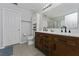 Spacious bathroom featuring a double vanity, tile floors and a large mirror at 1532 Angler Ave, Kissimmee, FL 34746