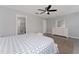 Bright bedroom featuring a ceiling fan, view to ensuite bathroom, and tile floors at 1532 Angler Ave, Kissimmee, FL 34746