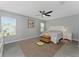 Bright bedroom featuring a ceiling fan, a large window, and tile floors at 1532 Angler Ave, Kissimmee, FL 34746