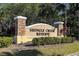 Attractive stone sign for Shingle Creek Reserve with well-maintained landscaping and mature trees at 1532 Angler Ave, Kissimmee, FL 34746