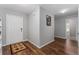 Inviting foyer with wood-look floors, neutral paint, and a door to the side and front door at 1532 Angler Ave, Kissimmee, FL 34746