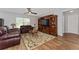 Cozy living room with hardwood floors, ceiling fan, and ample natural light at 1532 Angler Ave, Kissimmee, FL 34746