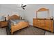 Comfortable main bedroom with wood furniture, neutral walls, ceiling fan, and decorative rug at 1532 Angler Ave, Kissimmee, FL 34746