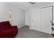 Cozy sitting room with a recliner, tile floors and sliding closet doors at 1532 Angler Ave, Kissimmee, FL 34746