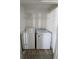 Efficient laundry area with washer, dryer, and convenient shelving at 158 Violet Ct, Poinciana, FL 34759