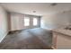 Spacious living room with lots of natural light and neutral carpeting at 158 Violet Ct, Poinciana, FL 34759