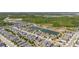 Beautiful aerial view of a residential neighborhood with serene ponds and lush green landscaping throughout the community at 17324 Bracken Fern Ln, Clermont, FL 34714