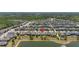 Expansive aerial view of community featuring homes, lush greenery, and a serene lake at 17324 Bracken Fern Ln, Clermont, FL 34714