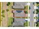 Aerial view showcases modern home with solar panels, well-manicured lawns, and neighborhood street at 17324 Bracken Fern Ln, Clermont, FL 34714