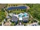 Aerial view of a community amenity center with a pool, playground, a pond and a clubhouse at 17324 Bracken Fern Ln, Clermont, FL 34714