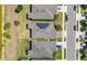 Aerial view showcases modern home with solar panels, well-manicured lawns, and neighborhood street at 17324 Bracken Fern Ln, Clermont, FL 34714