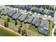 Aerial view of homes featuring backyard fences, lush lawns, and lake views at 17324 Bracken Fern Ln, Clermont, FL 34714