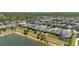 Aerial view of lakeside homes showcasing well-maintained yards, lush greenery, and serene water feature at 17324 Bracken Fern Ln, Clermont, FL 34714