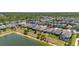 Aerial view of lakeside homes showcasing well-maintained yards, lush greenery, and serene water feature at 17324 Bracken Fern Ln, Clermont, FL 34714
