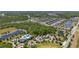 Aerial view of a planned community with a pool and amenity center, wooded areas and many homes at 17324 Bracken Fern Ln, Clermont, FL 34714