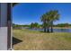 Beautiful backyard with a serene lake view and lush green lawn at 17324 Bracken Fern Ln, Clermont, FL 34714