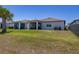 Well-maintained backyard and patio with a view of neighboring houses and lush greenery at 17324 Bracken Fern Ln, Clermont, FL 34714