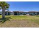 Wide backyard with a screened lanai, providing ample space for outdoor activities at 17324 Bracken Fern Ln, Clermont, FL 34714