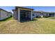 Backyard featuring a screened-in patio, perfect for outdoor relaxation and entertaining at 17324 Bracken Fern Ln, Clermont, FL 34714