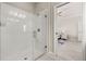 Modern bathroom showcasing a glass-enclosed shower with tiled walls and a view into the bedroom at 17324 Bracken Fern Ln, Clermont, FL 34714
