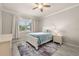Bright bedroom featuring a large window, a ceiling fan, and neutral paint at 17324 Bracken Fern Ln, Clermont, FL 34714