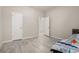 Comfortable bedroom featuring tile floors and two white doors at 17324 Bracken Fern Ln, Clermont, FL 34714