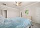 Comfortable bedroom with neutral walls, a ceiling fan, and an ensuite bathroom at 17324 Bracken Fern Ln, Clermont, FL 34714