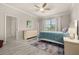 Cozy bedroom with a large window, neutral paint, ceiling fan and ensuite bathroom at 17324 Bracken Fern Ln, Clermont, FL 34714