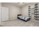 Comfortable bedroom featuring tile floors, a ceiling fan, and a window offering natural light at 17324 Bracken Fern Ln, Clermont, FL 34714