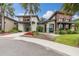 View of the clubhouse exterior with landscaping, flowers, and modern architecture at 17324 Bracken Fern Ln, Clermont, FL 34714
