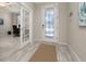 Open entryway with tile flooring, glass-paneled doors, and a view into the adjacent office at 17324 Bracken Fern Ln, Clermont, FL 34714