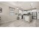 Eat-in kitchen featuring white cabinets, stainless steel appliances, an island with pendant lights, and a tiled backsplash at 17324 Bracken Fern Ln, Clermont, FL 34714