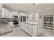 Open-concept kitchen with stainless steel appliances, granite countertops, white cabinets, and a center island at 17324 Bracken Fern Ln, Clermont, FL 34714