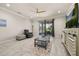 Bright living room featuring tile flooring, a ceiling fan, and sliding glass doors to an outdoor screened patio at 17324 Bracken Fern Ln, Clermont, FL 34714