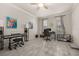 Bright office space with grey-toned tile, a ceiling fan, and lots of natural light streaming through the windows at 17324 Bracken Fern Ln, Clermont, FL 34714