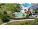 Aerial view of community splashpad with multiple water features, seating, and nearby restroom facilities, surrounded by palm trees at 17324 Bracken Fern Ln, Clermont, FL 34714