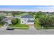 Aerial view of home and surrounding lot with lake and golf course views in the community at 1976 The Oaks Blvd, Kissimmee, FL 34746