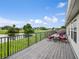 Back deck featuring an outdoor seating area overlooking a lush green yard and golf course at 1976 The Oaks Blvd, Kissimmee, FL 34746