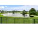 Backyard view of a pond and golf course surrounded by lush green vegetation at 1976 The Oaks Blvd, Kissimmee, FL 34746
