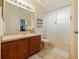 Bathroom featuring a shower-tub combo, toilet, wood vanity and ample storage space at 1976 The Oaks Blvd, Kissimmee, FL 34746