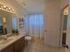 Bathroom featuring tile floors, single sink vanity, and a walk-in shower at 1976 The Oaks Blvd, Kissimmee, FL 34746