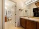Bathroom featuring a single vanity and a doorway leading to the toilet and shower-tub combo at 1976 The Oaks Blvd, Kissimmee, FL 34746