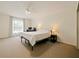 Bright bedroom with carpet, ceiling fan, and natural light from the window at 1976 The Oaks Blvd, Kissimmee, FL 34746
