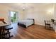 Bedroom with laminate floors, sliding glass doors to patio, piano and desk at 1976 The Oaks Blvd, Kissimmee, FL 34746