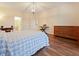Bedroom featuring laminate floors, dresser, piano, and access to ensuite bathroom at 1976 The Oaks Blvd, Kissimmee, FL 34746