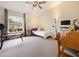 Spacious bedroom featuring a ceiling fan, large window, neutral color scheme and plush carpeting at 1976 The Oaks Blvd, Kissimmee, FL 34746