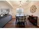 Elegant dining area featuring a stylish light fixture, wood floors and comfortable upholstered chairs at 1976 The Oaks Blvd, Kissimmee, FL 34746