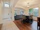 Dining room featuring hardwood floors, chandelier, arched doorways, and an open view to the living room at 1976 The Oaks Blvd, Kissimmee, FL 34746