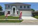 Charming two-story home featuring a well-maintained lawn and an attached two-car garage at 1976 The Oaks Blvd, Kissimmee, FL 34746